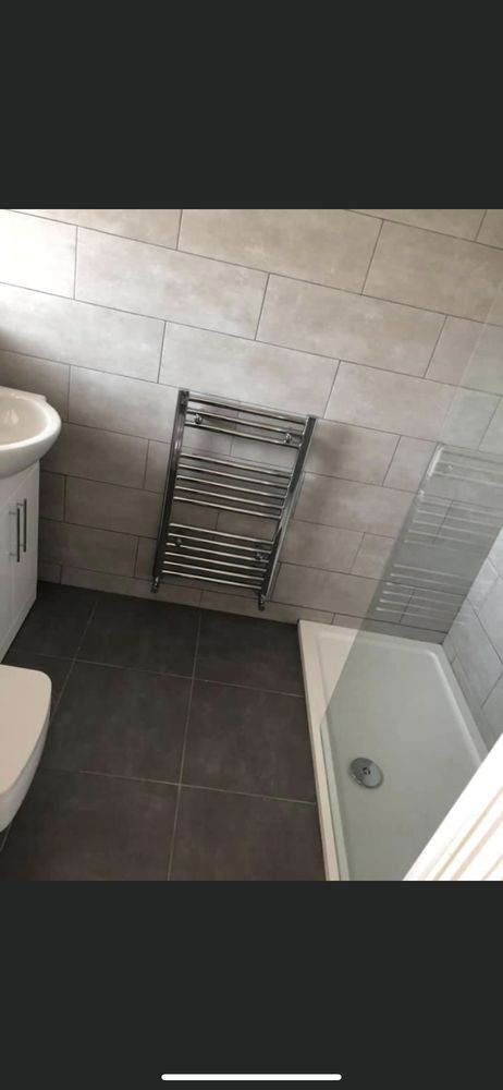 Modern tiled bathroom with heated towel rail